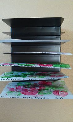 a stack of cards sitting on top of each other in front of a white wall