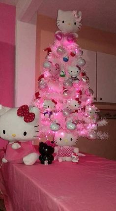 a pink christmas tree with hello kitty ornaments