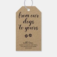 a brown tag with the words from our dogs to yours on it and a paw print