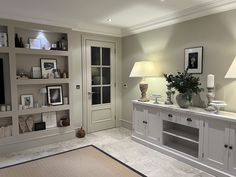 a living room filled with lots of white furniture