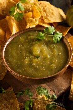 a bowl of salsa with tortilla chips and an apple