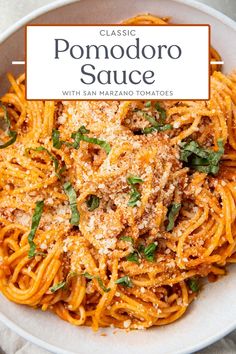 a white bowl filled with pasta and topped with parmesan cheese