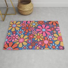 a colorful rug with flowers on it next to a basket