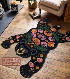 a black bear rug with colorful flowers on it