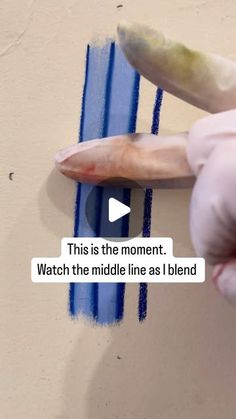 someone is painting the wall with blue paint and pointing at it that says, this is the moment watch the middle line as i blend