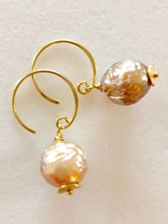 "Soft peach glow Chinese freshwater Kasumi pearls wire wrapped on handmade 24k gold vermeil ear wires Beautiful 11mm Chinese kasumi pearls with characteristic iridescent bumpy surface are full of color and texture and highly lustrous. They display a full array of metallic colors including dusty rose pink, peach and bronze. Stunning kasumi pearls are wire wrapped on 24k gold vermeil handmade ear wires with tiny gold vermeil wavy disc accents. Total length is 1 1/4\". Also in Sterling silver." Handmade Delicate Pearl Earrings, Delicate Handmade Gold Pearl Earrings, Handmade Delicate Baroque Pearl Earrings, Handmade Baroque Pearl Pear-shaped Earrings, Handmade Baroque Pearl Earrings In Pear Shape, Handmade Pear-shaped Baroque Pearl Earrings, Handmade Round Baroque Pearl Earrings, Handmade Baroque Pearl Round Jewelry, Handmade Baroque Pearl Earrings For Gift