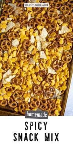 homemade spicy snack mix in a baking pan with text overlay that reads homemade spicy snack mix