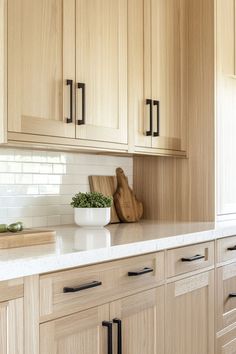 a kitchen with wooden cabinets and white counter tops, including a cutting board on the island