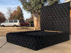 a large bed sitting in the middle of a driveway