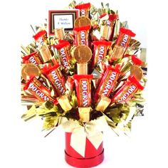 a bouquet of chocolates and candies in a red box