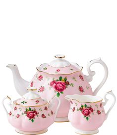 a pink tea set with roses on it