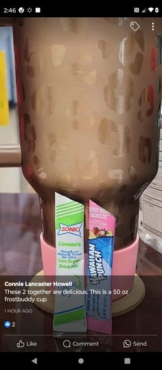 a chocolate drink in a cup with candy bars on the side and an advertizer for milkshake