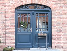 a blue front door with a wreath on it