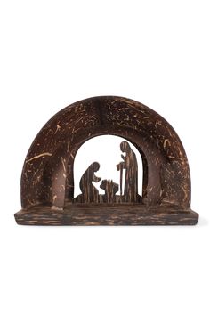 the nativity scene is made out of wood and has an arched doorway that leads into it