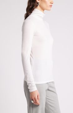 Lightweight, soft and warm, this trim turtleneck is also versatile, ensuring its place at the top of your rotation. Turtleneck Long sleeves 70% Tencel® lyocell, 30% wool Tencel lyocell is a more-sustainably produced fiber made with closed-loop processing Machine wash, tumble dry Imported White Fine Knit Turtleneck Top, Fine Knit Long Sleeve Mock Neck Top For Layering, White Fine Knit Turtleneck With Funnel Neck, Elegant Turtleneck Long Sleeve Top For Layering, Elegant Long Sleeve Turtleneck Top For Layering, White Long Sleeve Mock Neck Top For Layering, Stretch Fine Knit Mock Neck Top For Layering, Stretch Fine Knit Turtleneck For Layering, Versatile Fine Knit Turtleneck Top