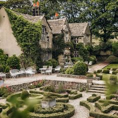 an old house with formal garden and seating area