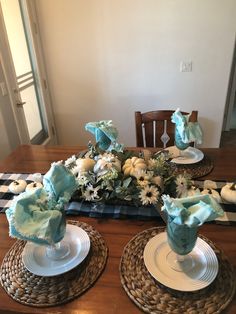 the table is set with blue and white flowers