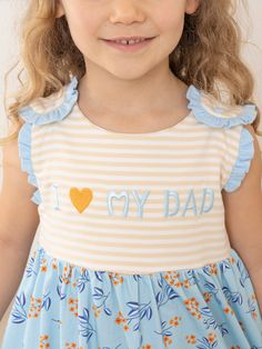 Bask in the sunny warmth of familial bonds with our latest exclusive MNC Basics collection: Family Love. Our soft, comfortable, high quality fabric is back in soft stripes, dainty florals, and ruffles galore. With embroidered messaging expressing love to the family, your little ones will love these spring basics! Show your daughter's love for Dad with this playful Blue Floral Dad Love Ruffle Dress! Featuring a charming embroidered "I ❤️ My Dad" on the striped bodice and adorable floral skirt wit Striped Ruffle Dress For Playtime, Striped Summer Dresses For Playdate, Striped Dresses For Summer Playdate, Spring Basics, Expressing Love, My Dad, Family Love, Daughter Love, Botanical Art