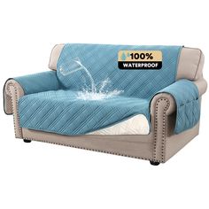 a couch covered in a blue cover with the words 100 % waterproof on it