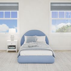 a bedroom with two windows and a bed in the middle is blue, white and gray