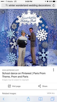 two people standing in front of a backdrop with snowflakes and an arch that says, annual christmas holiday build