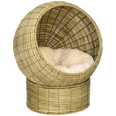 a wicker chair with a white blanket on it's back and the seat is shaped like a ball