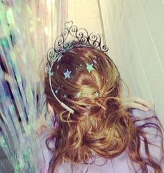 a girl with long hair wearing a tiara