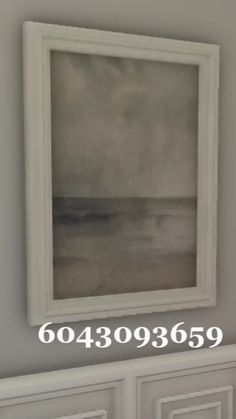 a painting hanging on the wall above a dresser in a room with white cabinets and drawers