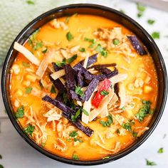 a bowl of soup with tortilla chips on top