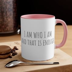 a pink and white coffee mug with the words i am who i am and that is enough