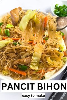 a plate full of noodles and vegetables with chopsticks in the bowl next to it