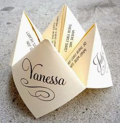 an origami fortune card holder with the word's name written on it