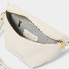 Our Maya Belt Bag in off white is here to accompany you on every summer adventure. With a captivating selection of three warm-weather ready colorways, this vegan leather gem effortlessly blends fashion with functionality. The adjustable wide strap guarantees a comfortable fit, while the internal pocket ensures effortless organization of small essentials. The gold-tone zip fastening not only adds a touch of elegance but also secures belongings, allowing for carefree dancing at festivals and beyon Cream Belt Bag For Everyday Use, Modern White Belt Bag For Everyday Use, White Belt Bag For Everyday Use, Summer Everyday Belt Bag With Removable Pouch, Versatile White Belt Bag For Everyday Use, Cream Belt Bag With Adjustable Strap For Daily Use, Versatile Everyday White Belt Bag, Everyday Beige Belt Bag With Detachable Strap, Everyday Versatile White Belt Bag