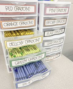 the drawers are labeled with different types of crayons and other writing materials on them