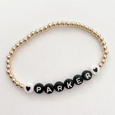 This listing is for one 14k gold filled 4mm beaded bracelet with black letters beads and the white hearts. Please leave name or initials in the notes section at checkout. This is the perfect stack bracelet. Gold filled means the bracelet will not tarnish or peel. Sizing: 5.5--kids 5.75-big kids 6-6.5-small adult wrist 6.75-sm/medium wrist 7-7.25-medium Classic Personalized Beaded Bracelets For Everyday, Everyday Black Name Bracelet With Round Beads, Personalized Black Beaded Name Bracelet, Everyday Black Stretch Bracelet With Custom Name, Personalized Gold Bracelet, Gold Beaded Bracelets, Initial Bracelet Gold, Name Bracelets, Bracelet Keychains