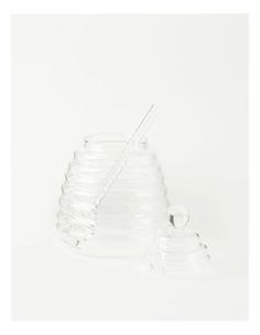 a set of three clear vases sitting next to each other on a white surface