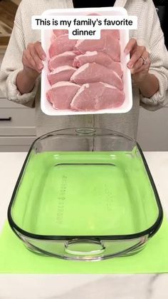 a woman holding a plate with raw meat in it and the words, this is my family's favorite dinner