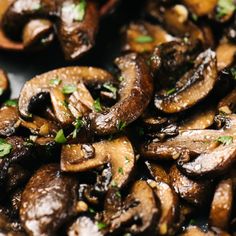 mushrooms with parsley on top in a pan ready to be cooked and served for dinner