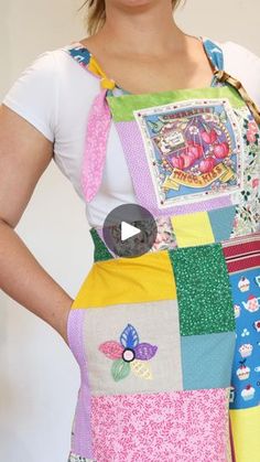 a woman wearing an apron made out of patchwork material