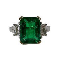 Emerald Weight: 3.27 CTS, Measurements:10.22 x 7.79 x 5.54 mm, Diamond Weight: 0.60 CT (G-VS), Metal: Platinum/18K Yellow Gold Basket, Ring Size: 7, Shape: Emerald-Cut, Color: Vivid Green, Hardness: 7.5-8, Birthstone: May, CD Certified Formal Green Platinum Diamond Ring, Oval Emerald Ring With Accent Stones In Platinum, Emerald Cut Diamond Gemstones For Formal Events, Emerald Cut Diamond Gemstone For Formal Occasions, Formal Emerald Cut Diamond Gemstone, Emerald Cut Diamond For Formal Occasions, Formal Gia Certified Emerald Gemstones, Green Octagon Platinum Ring, Green Platinum Rings With Accent Stones