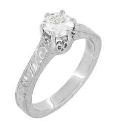 a white gold engagement ring with an engraved design