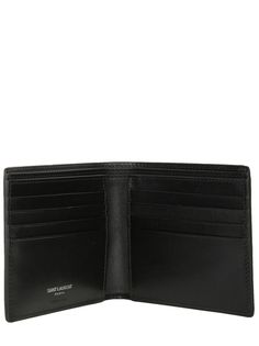 Saint Laurent's billfold wallet crafted in black smooth leather adorned with the unmistakable tonal metal interlocking YSL signature. Fabric-lined interior with two notes compartments, two slip pockets and eight card slots.Gender: MENMaterial: 100% CALF SKINColor: BLACKMade in: ITProduct ID: 4532760SX0E1000*Import tax/duty will be calculated at checkout (If applicable) Designer Trifold Wallets For Formal Occasions, Designer Rfid Blocking Wallet For Formal Occasions, Designer Bifold Wallets For Formal Occasions, Modern Trifold Wallet With Coin Pocket For Formal Use, Designer Trifold Wallet For Formal Occasions, Designer Business Trifold Wallet, Designer Bifold Business Wallet, Designer Trifold Wallet With Coin Pocket For Business, Modern Leather Wallets With Logo Plaque