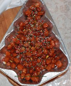 a christmas tree made out of meatballs and sprinkles on a tray