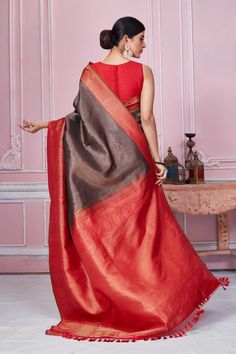 Beautiful brown Banarasi saree with red zari border is a perfect choice for festive occasions. It comes with a matching blouse piece. Disclaimer: The shown stitched blouse on the model is for display purpose only. The saree comes with a matching blouse piece and finished with fall and piko. Brown Saree With Zari Weaving For Puja, Elegant Red Saree With Border, Brown Banarasi Saree, Elegant Red Banarasi Silk Pre-draped Saree, Semi-stitched Red Saree With Border, Semi-stitched Red Saree With Embroidered Border, Banarasi Sari, Latest Designer Sarees, Banarasi Saree