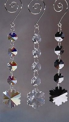 three different types of earrings hanging from hooks