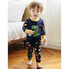 DESCRIPTION These fun, comfortable cotton pajamas make the perfect addition to any jammie collection. These jammies are 100% cotton, soft and comfortable for your little dinosaur lover. Pants are pull-on with wide elastic waist band, and the top and pants are ribbed at the waist and cuffs. Both also have a tagless label for your child's comfort. The fit is super snug so you may need to go up a size or if your child is on the cusp of going up a size soon, you may want to go up two sizes. DETAILS Fun Cotton Loungewear Set, Family Matching Cartoon Print Sleepwear, Fun Cartoon Print Sleepwear For Loungewear, Fun Cartoon Print Sleepwear For Playtime, Fun Cartoon Print Sleepwear For Bedtime, Fun Cartoon Print Sleepwear, Cotton Long Sleeve Dinosaur Print Set, Cotton Long Sleeve Sets With Dinosaur Print, Cute Dinosaur Print Playwear Sets