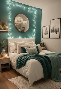 a bedroom decorated in teal and white with lights on the wall