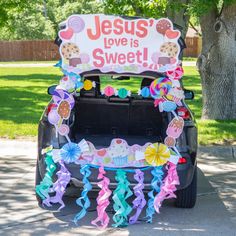 a car decorated with candy and cupcakes is parked on the side of the road