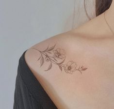 a woman with a flower tattoo on her shoulder