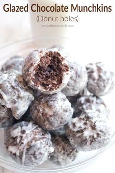 chocolate munchkins are stacked on top of each other in a glass bowl with the words glazed chocolate munchkins donut holes